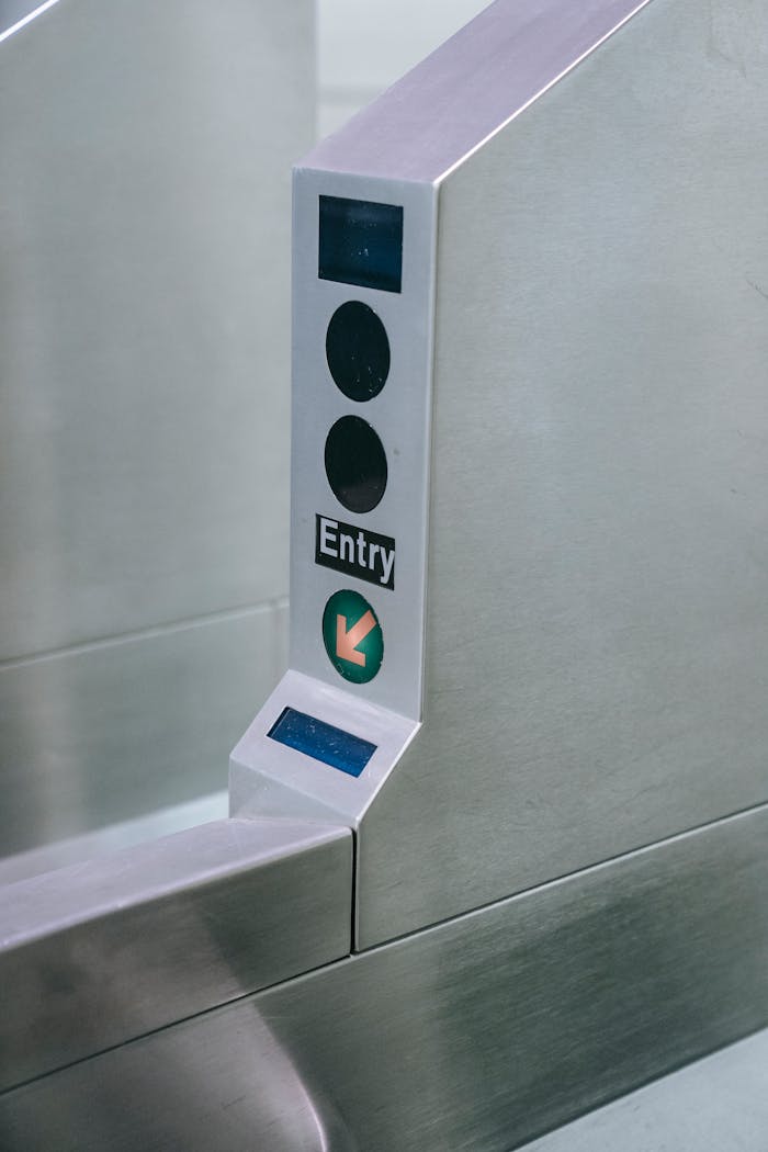 Close-up of a metro station entry gate with scanner and directional arrow.